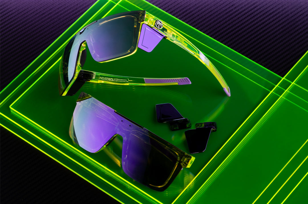Two pairs of the Performance Quatro Sunglasses: Antifreeze Z87+ on a neon green platform