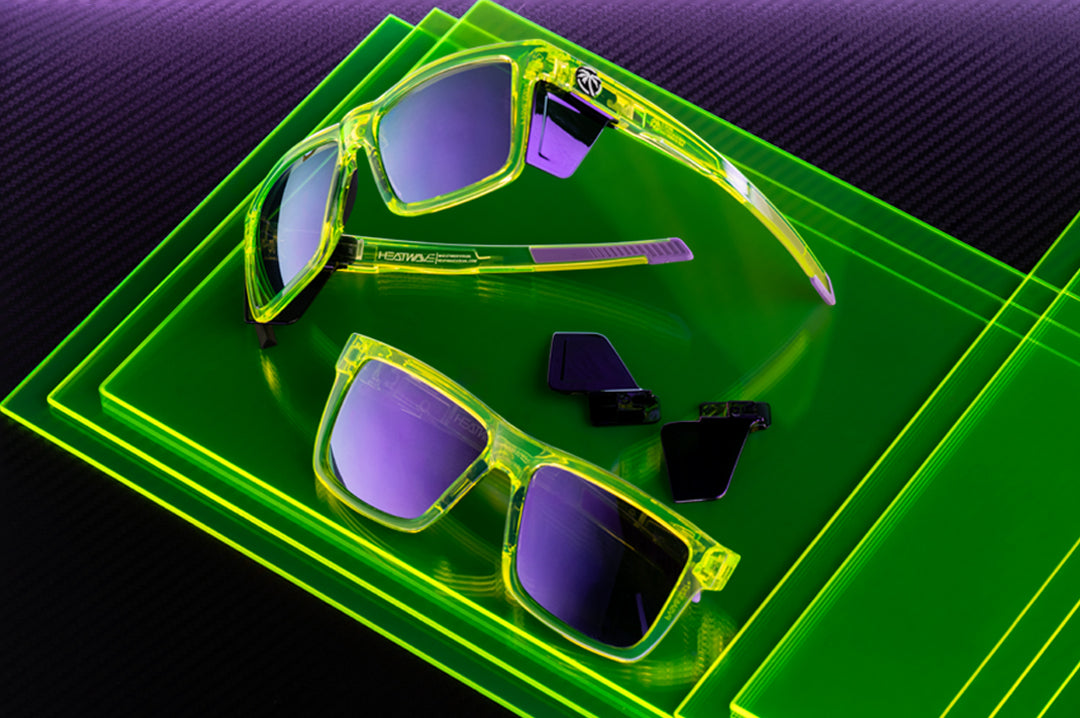 Two pairs of the Performance Vise Sunglasses: Antifreeze Z87+ on a neon green platform