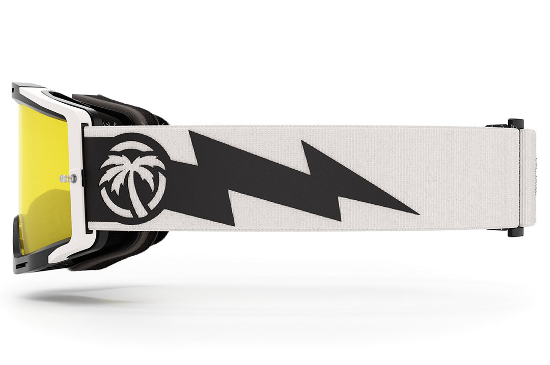 Side view of the Heat Wave Visual MXG 250 Motorsport Goggles in the Rusty Butcher white/black color with a hi vis yellow lens.