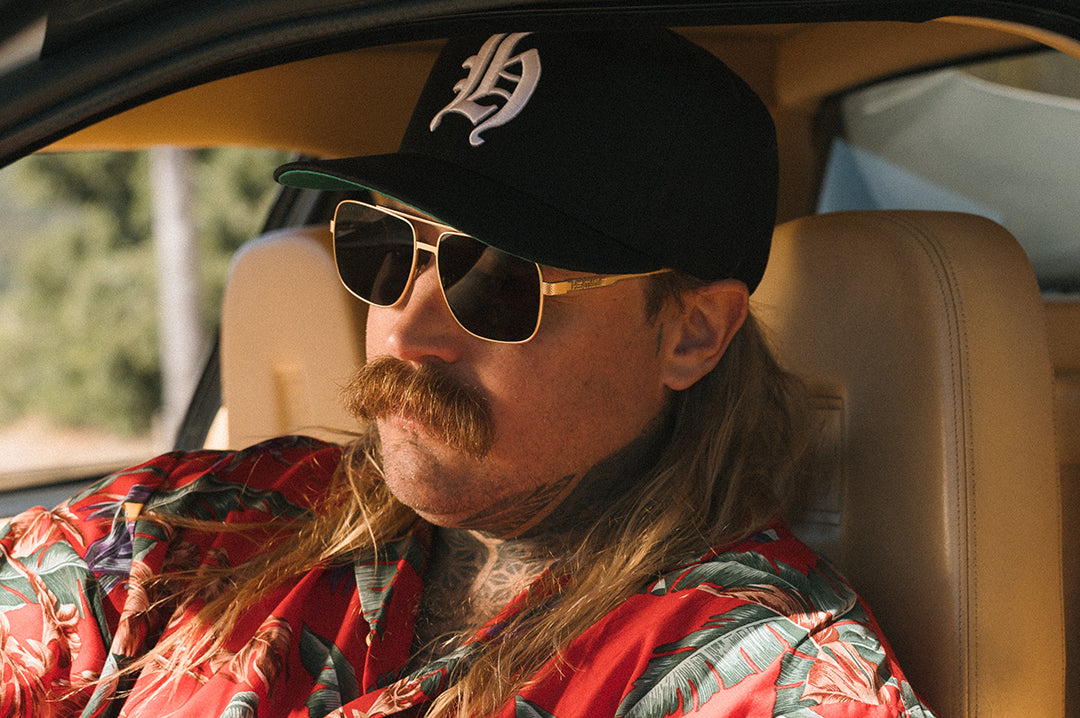 Man wearing the Heat Wave Magnum Hat - Black sitting in a car
