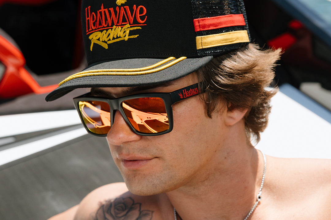 Man wearing the Heat Wave Offshore Hat - Black on a boat