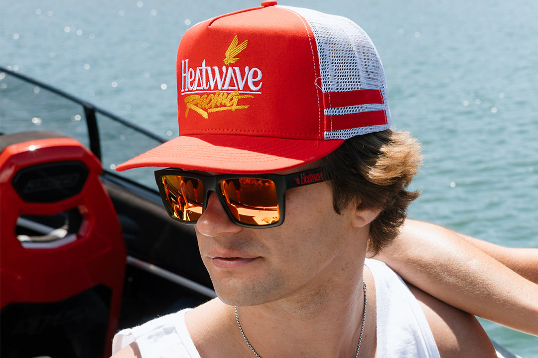 Man wearing the Heat Wave Offshore Hat - Red on a boat