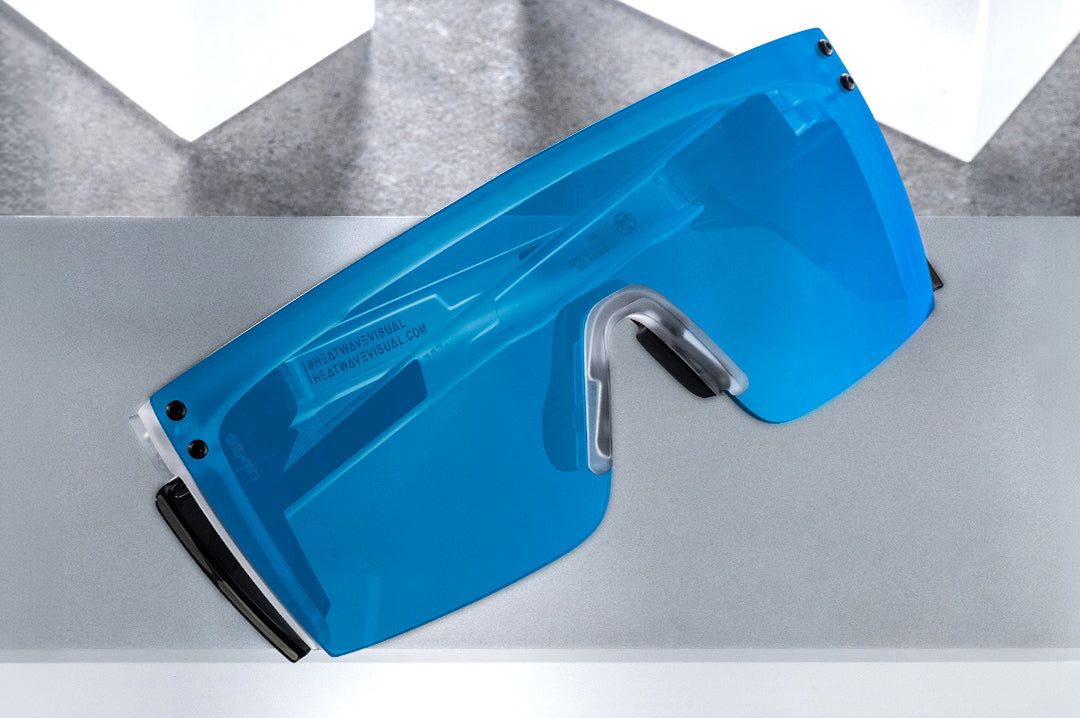 Indoor studio shot of the Performance Lazer Face Sunglasses: Vapor Frost Frame Coastal Lens Z87+ on a concrete block.