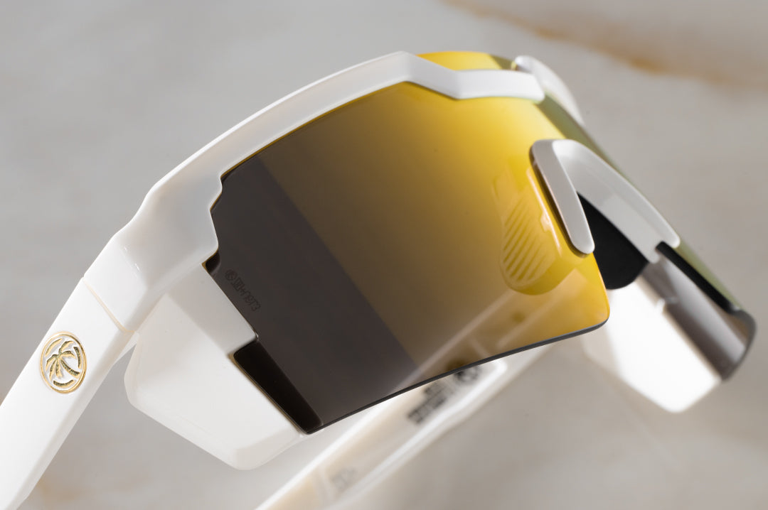 Close up side angle shot of the Future Tech Sunglasses: GLOSS WHITE Gold Lens Z87+ on a counter
