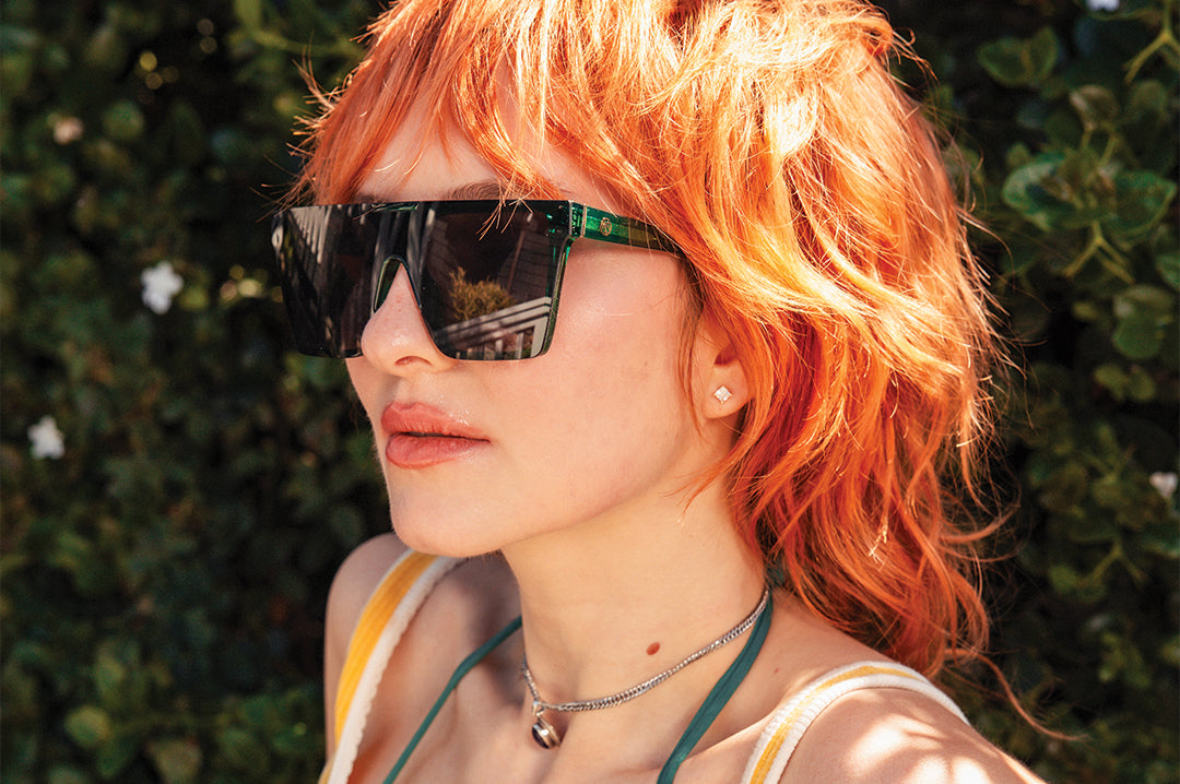 Woman wearing the Clarity Sunglasses: Cycad Green