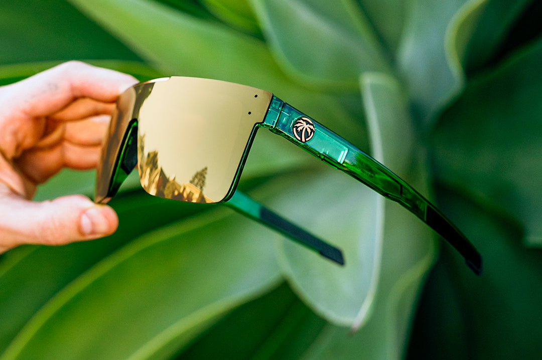 Hand holding the Performance Quatro Sunglasses: Cycad Green Z87+