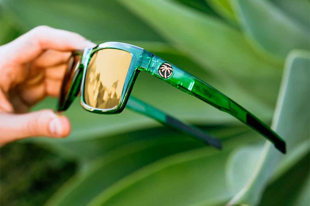 Hand holding the Performance Vise Sunglasses: Cycad Green Z87+