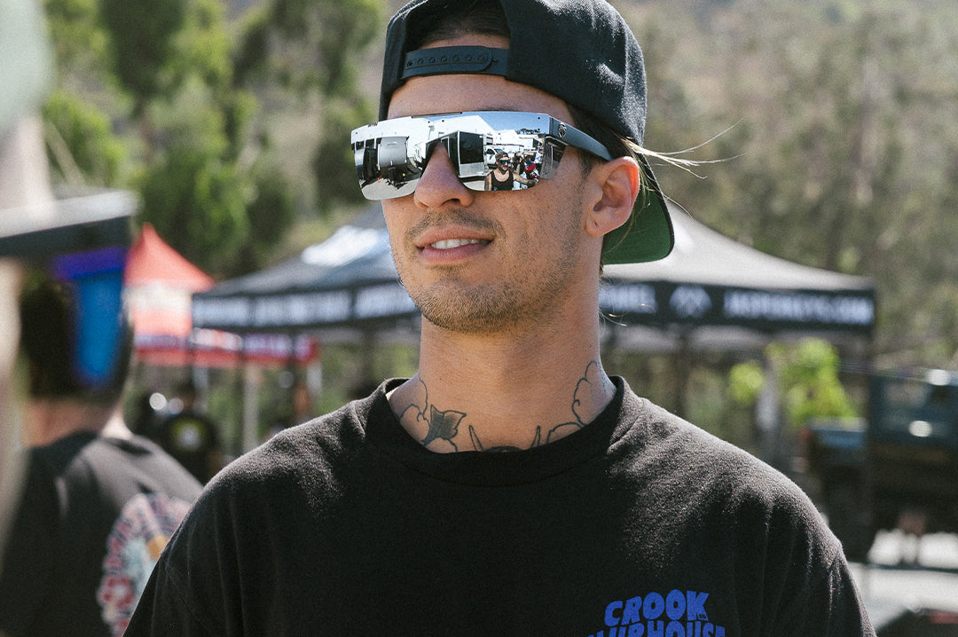 Dude at an event rocking the Heat Wave Visual Performance Quatro Sunglasses with black frame, silver lens and matching colored side shields.