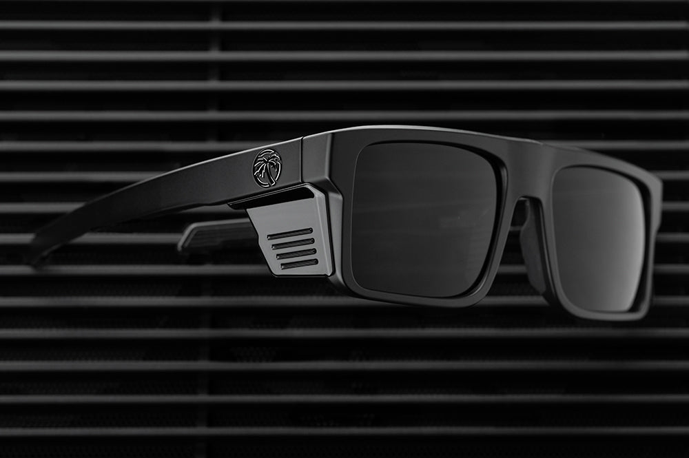 Lying on the ground is the Heat Wave Visual Performance Rayth Ultra Black Sunglasses.