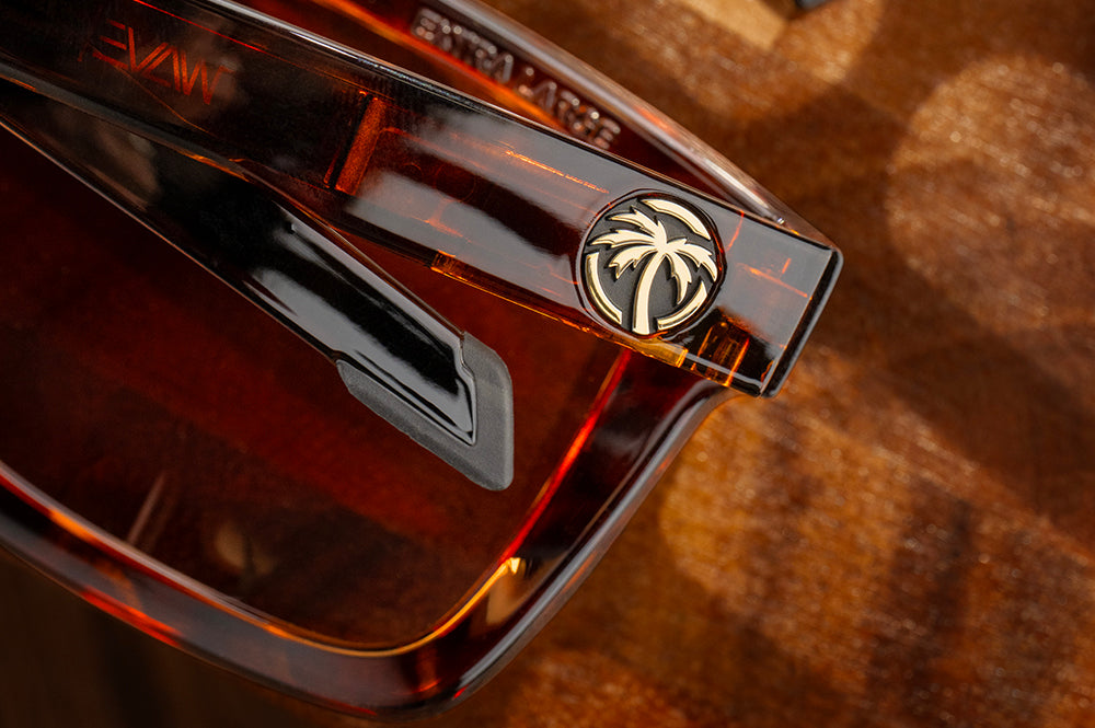 Close-up of the Heat Wave Visual Performance Vise Tortoise Sunglasses arm emblem.