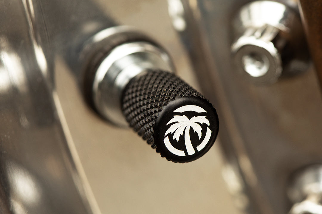 Heat Wave Visual black valve stem caps on a wheel.