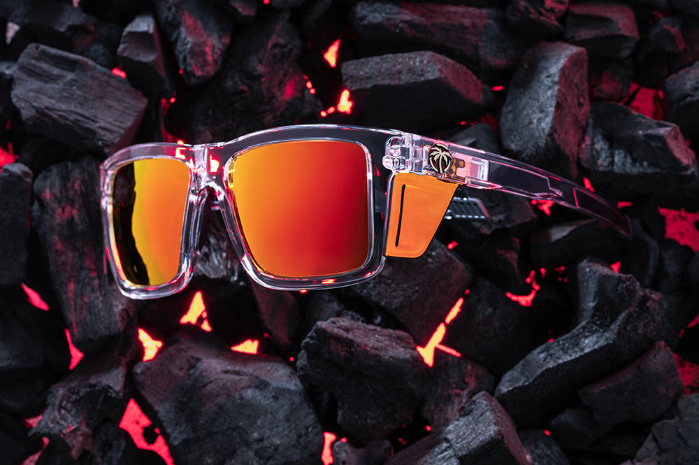 Side View of Heat Wave Performance XL Vise Vapor Clear Sunblast safety sunglasses with orange red side shields and hot bbq coals behind them.