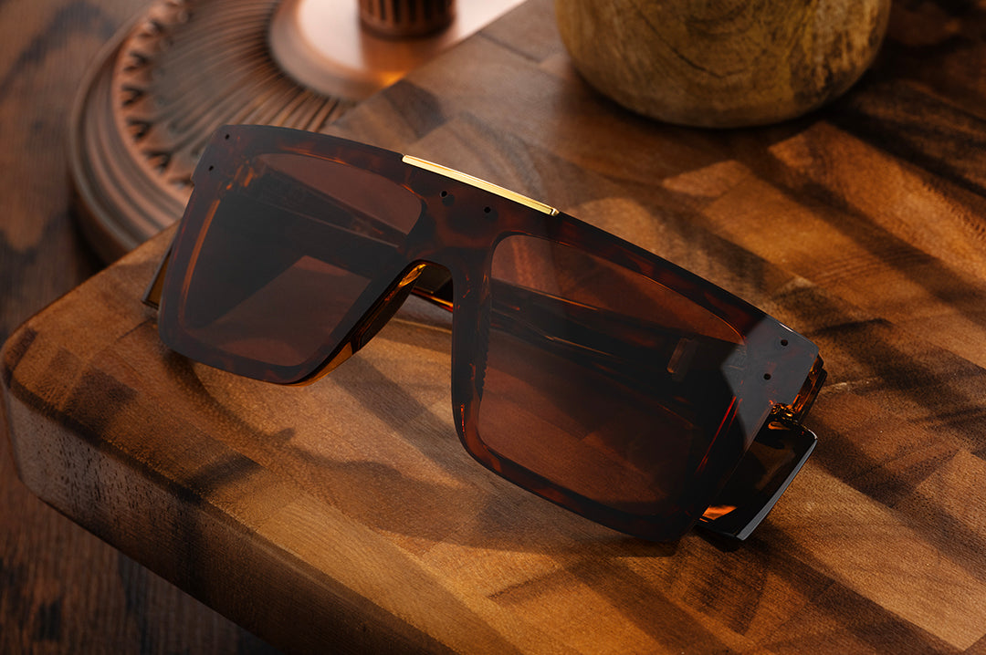 Front  of Heat Wave Z87+ Performance Quatro Tortoise safety sunglasses sitting on wooden table.