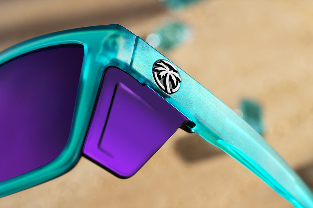 Close up of purple side shield of Heat Wave Performance XL Vise sunglasses with purple lenses and aqua frame