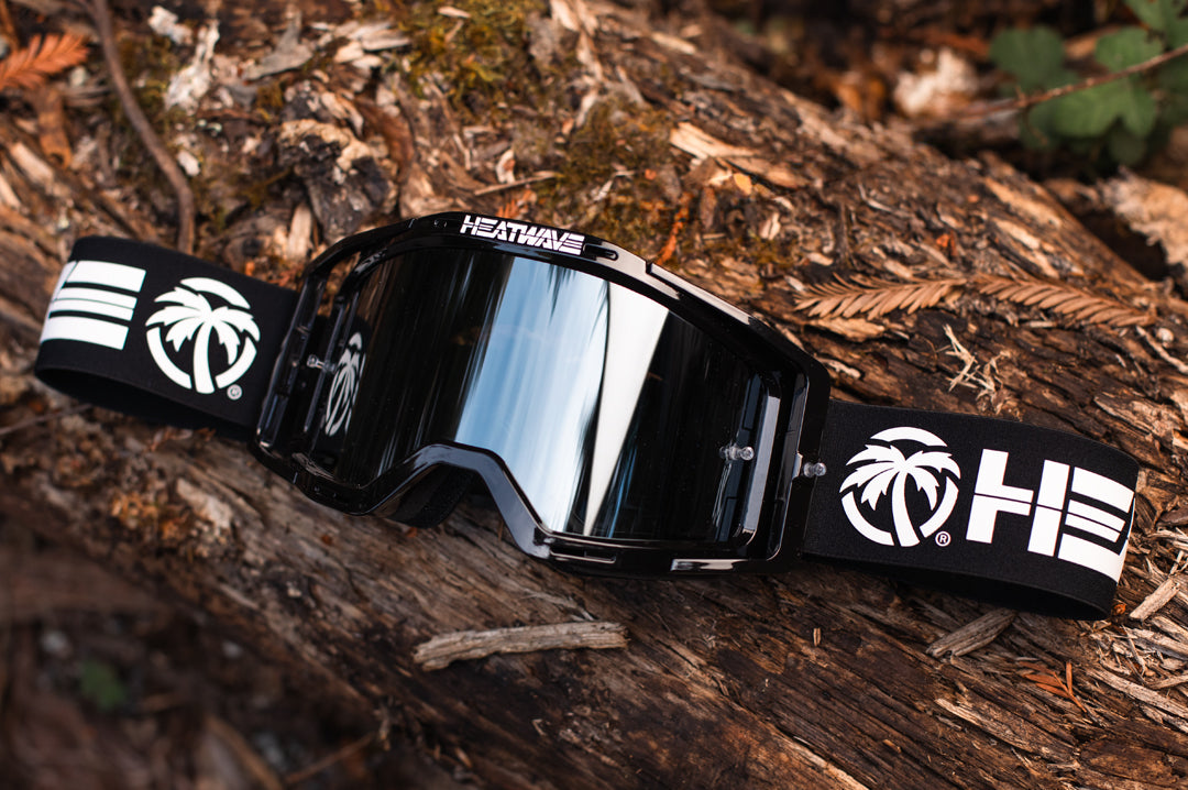 Heat Wave Visual MXG 250 Motosport Goggle on a tree log.