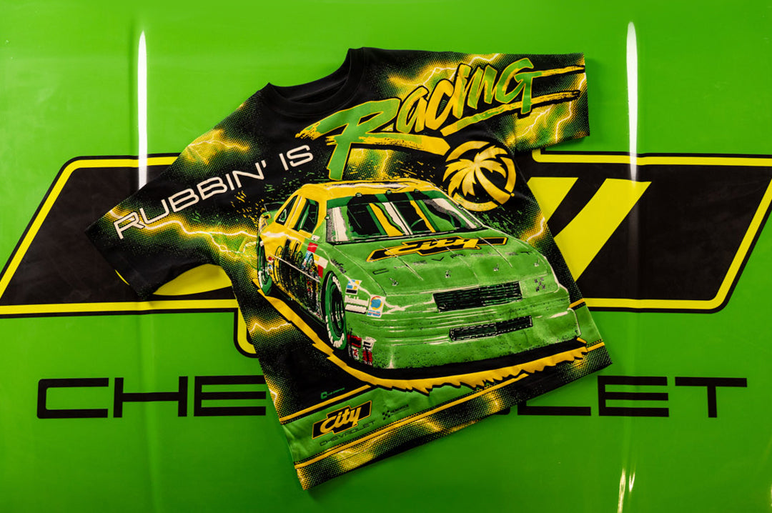 Lying on the hood of a car is the City of Chevrolet X HWV T-shirt.