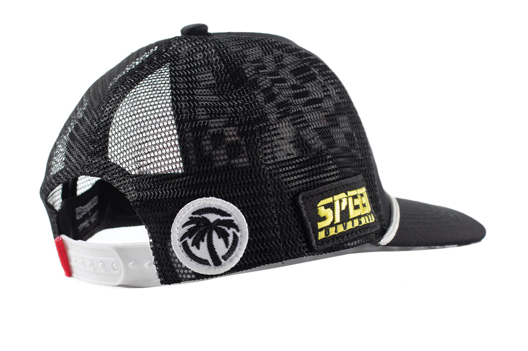 Side angled shot of the Little Trouble X Heat Wave Youth Trucker Hat on a white background. 