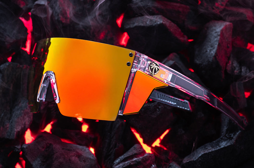 Close up of Heat Wave Performance Lazer Face Vapor Clear Sunblast safety sunglasses with hot bbq coals behind them.