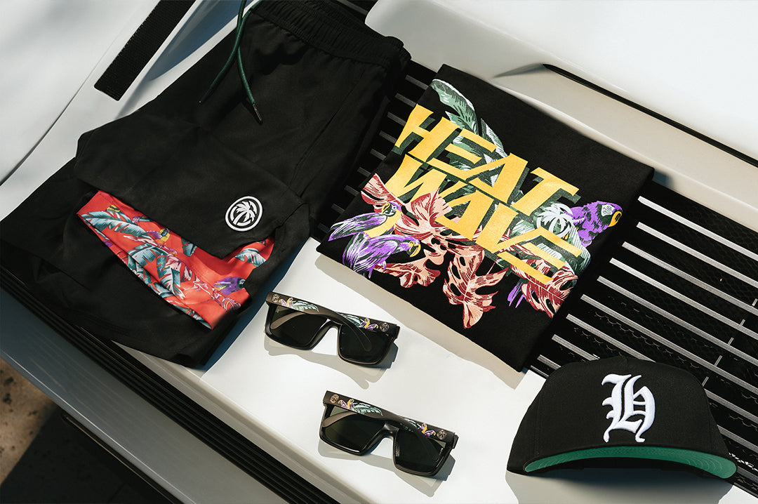 The Heat Wave Magnum T-Shirt - Black and whole collection placed on top of a car
