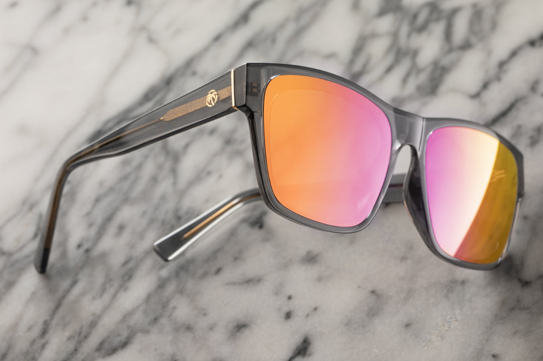 Lying on a marble table is the Heat Wave Visual Marylin Sunglasses with quartz frames and rose gold lenses.