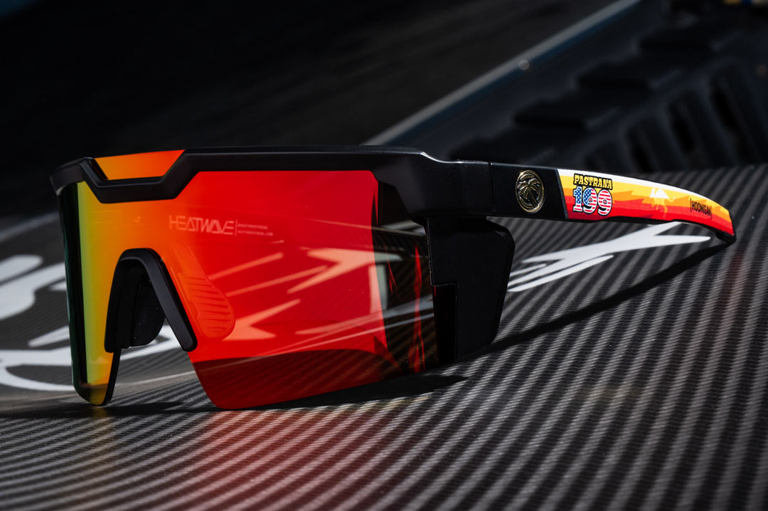 Lying on a carbon fiber wing is the Heat Wave Visual Future Tech Hoonigan Pastrana Sunglasses.  