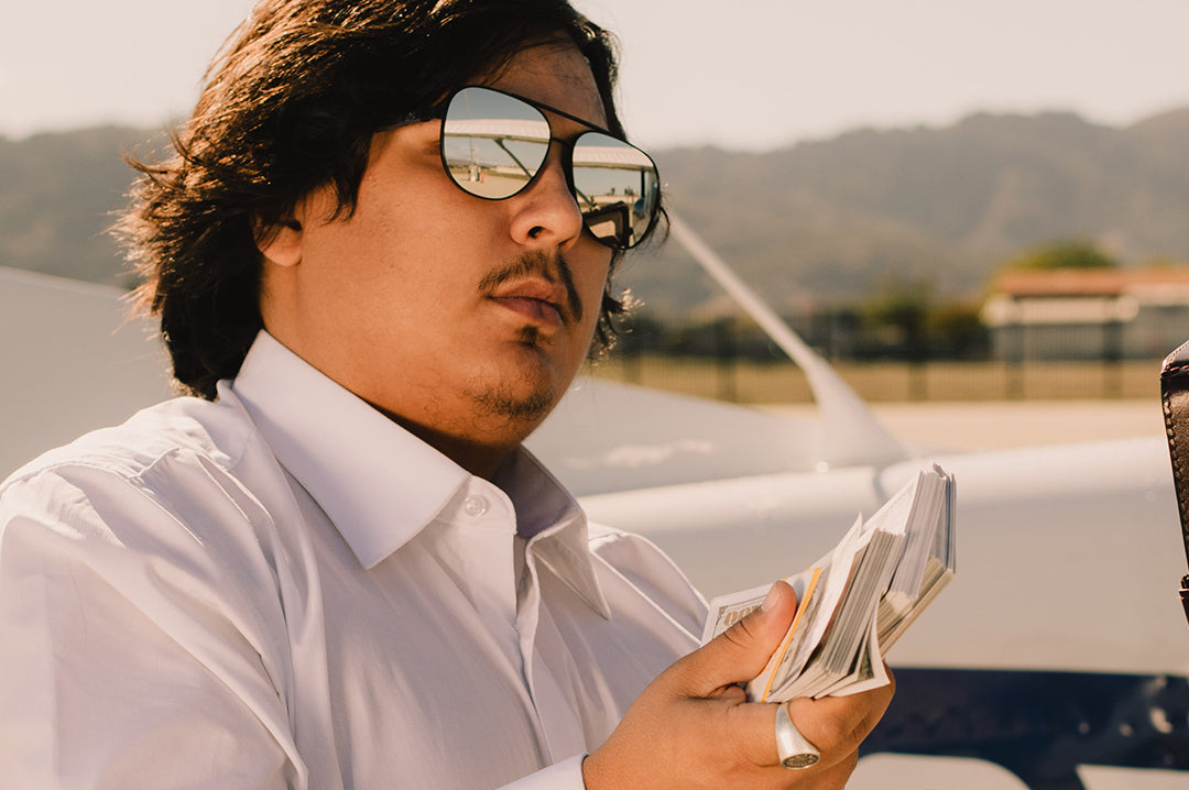 Zack rocking the Heat Wave Visual Incline Sunglasses with gun metal frame and silver lenses.