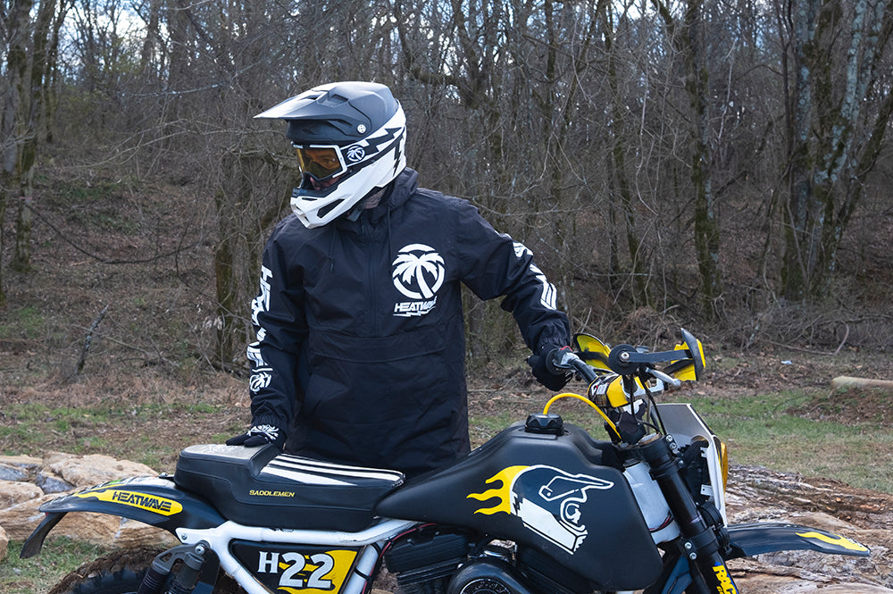Rusty Butcher wearing his Heat Wave Goggles and helmet next to his Harley Motorcycle