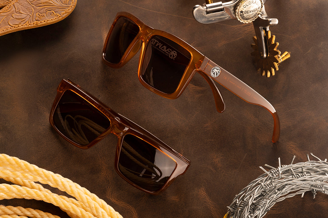 Two pairs of the XL VISE Sunglasses: Saddle Z87 on a wood table. 