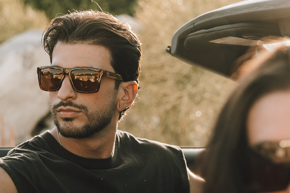 Young dude rocking the Heat Wave Visual Performance Vise Sunglasses with tortoise frame, brown lenses and matching side shields. 