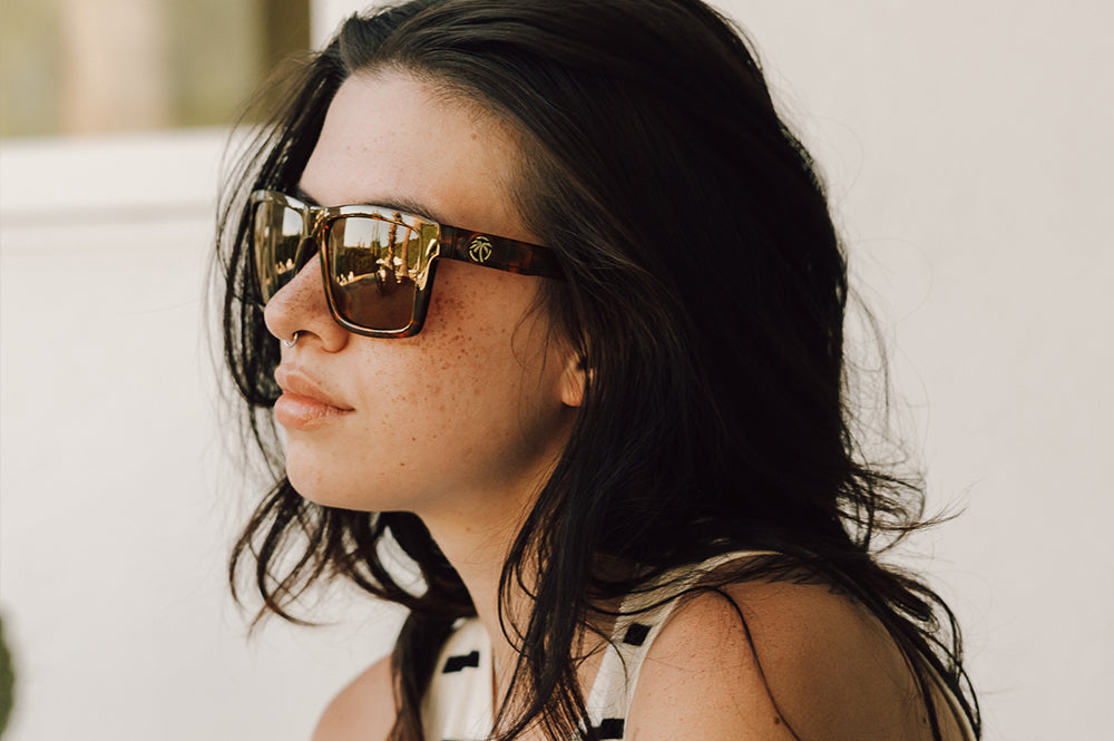 Women sitting outside wearing the Heat Wave Visual Performance Vise Tortoise Sunglasses. 
