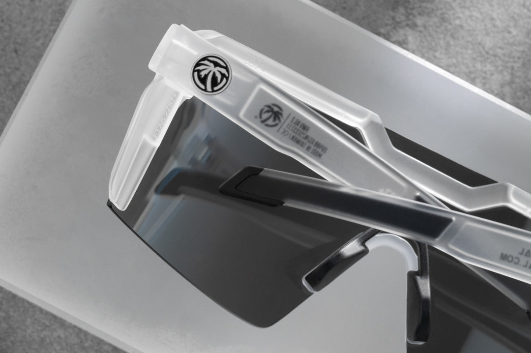 Close up backside shot of the Future Tech Sunglasses: Vapor Frost Frame Coastal Lens Z87+ with clear side shields on a concrete block.