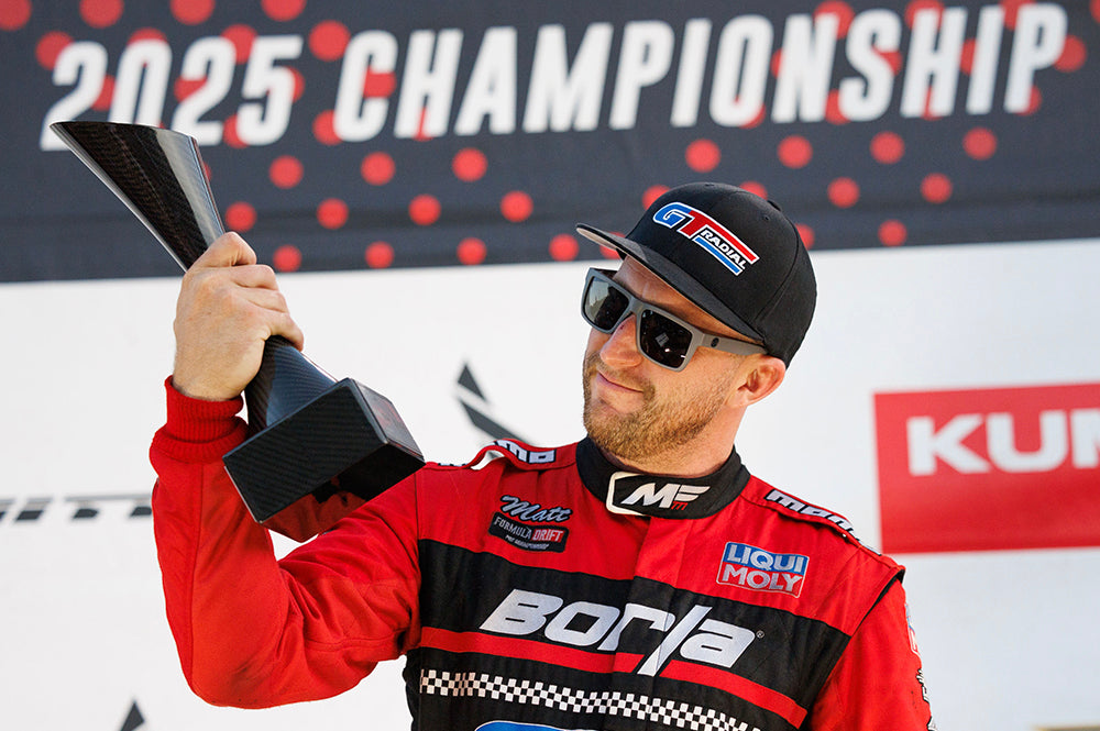 Drift racer Matt Field wearing the new Z87 Vise satin grey safety sunglasses while holding his 1st place trophy.