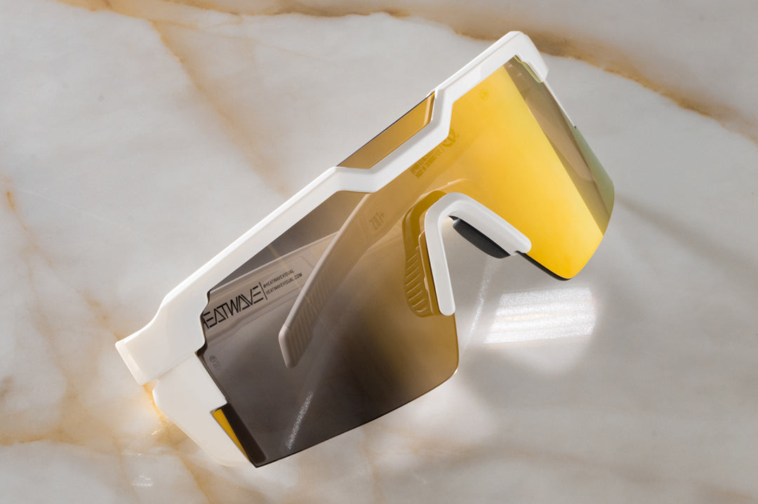 Close up angle shot of the Future Tech Sunglasses: GLOSS WHITE Gold Lens Z87+ on a counter