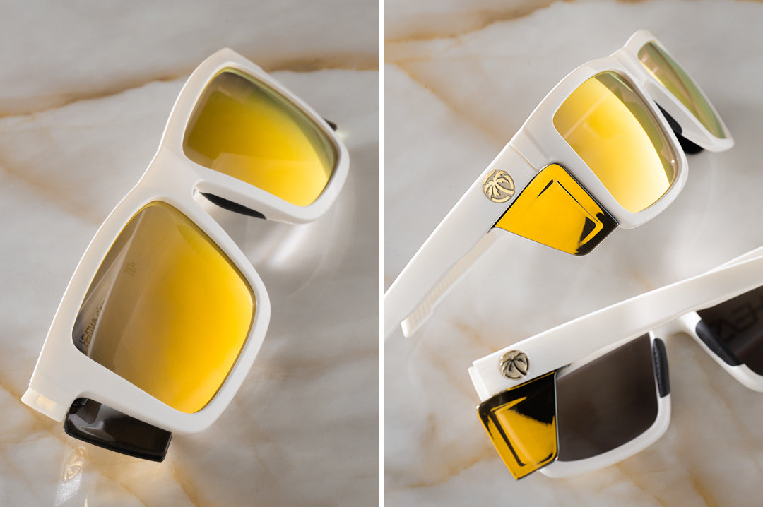 Two pairs of the Performance Vise Sunglasses: GLOSS WHITE Gold Lens Z87+ on a counter