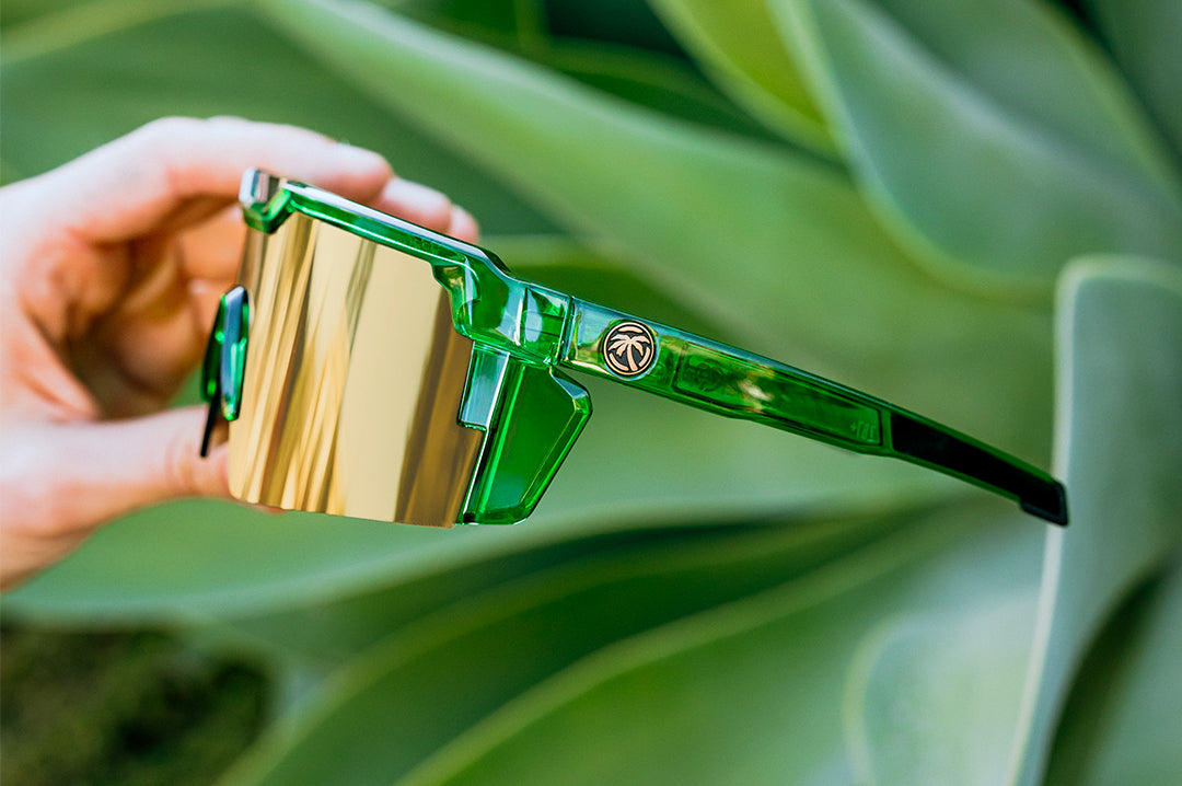 Hand holding the Future Tech Sunglasses: Cycad Green Z87+