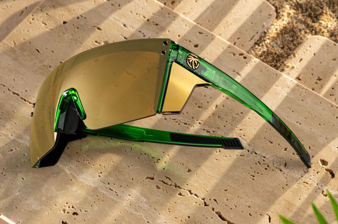 3/4 angle of the Performance Lazer Face Sunglasses: Cycad Green Z87+ on concrete