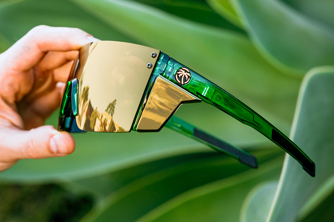 Hand holding the Performance Lazer Face Sunglasses: Cycad Green Z87+