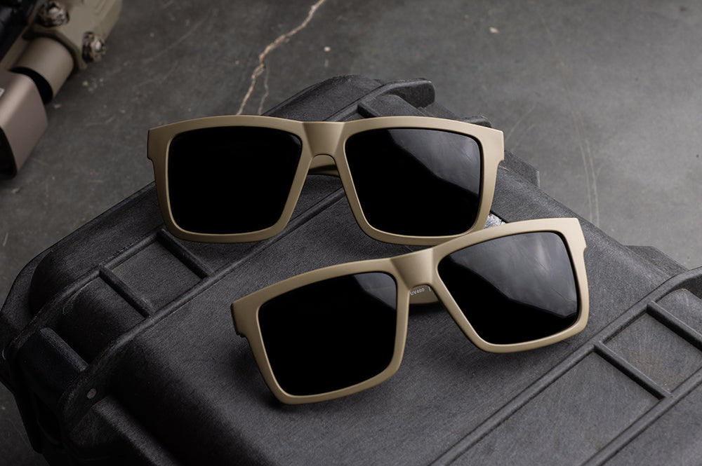 Two pairs of  VISE Z87 Sunglasses DESERT TAN: Black Lens sitting on a case