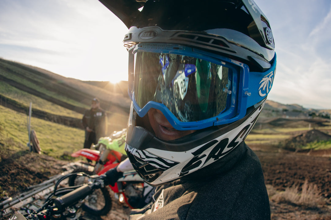 Motor cross rider wearing the Heat Wave Visual MXG 250 Motosport Goggle in the billboard icon arc flash blue color way. 