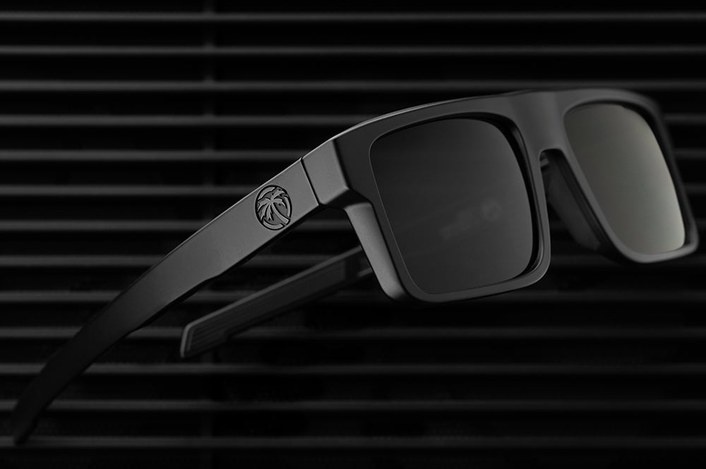 Heat Wave Visual Performance Rayth Ultra Black Sunglasses lying on a floor. 