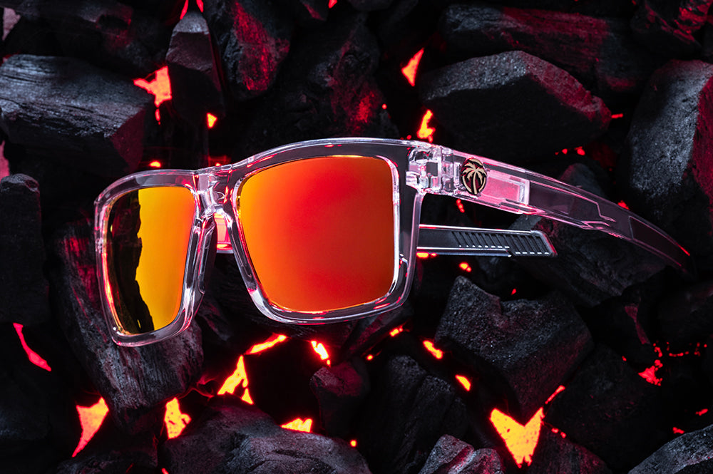 Side View of Heat Wave Performance XL Vise Vapor Clear Sunblast safety sunglasses with the side shields removed and hot bbq coals behind them.