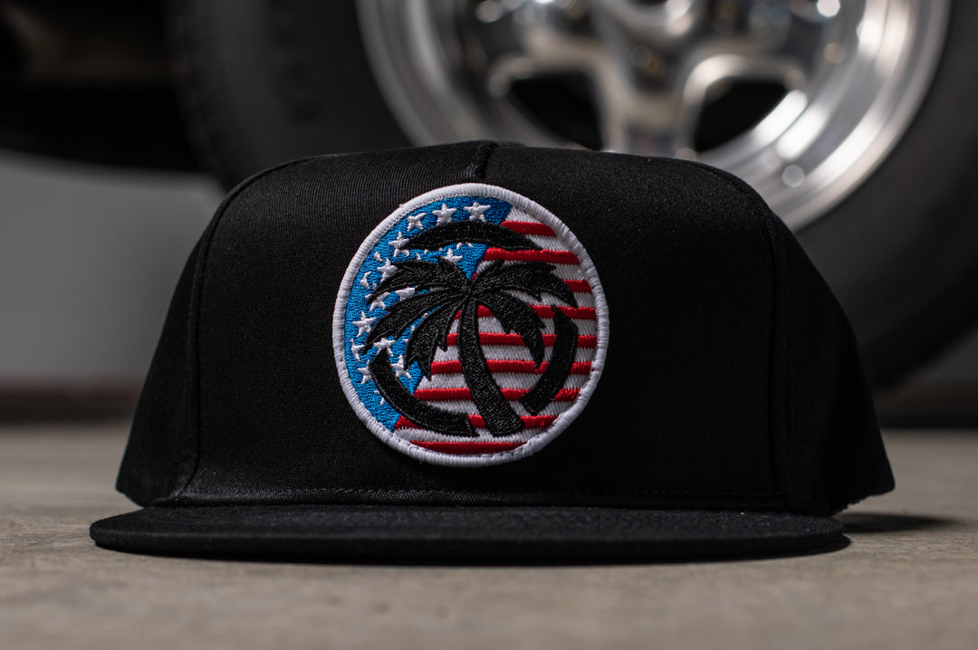 Front of Heat Wave Visual black snapback hat with USA icon patch.