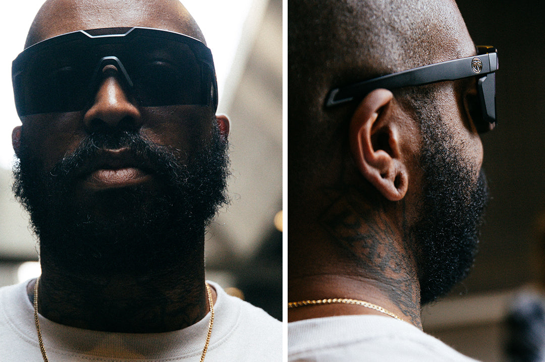 Bearded man wearing Heat Wave Visual Future Tech Sunglasses with black frame and black lens.