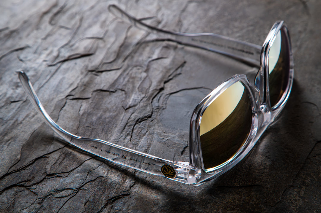 Heat Wave Visual Clear Vise Sunglasses upside down on a rock slab.