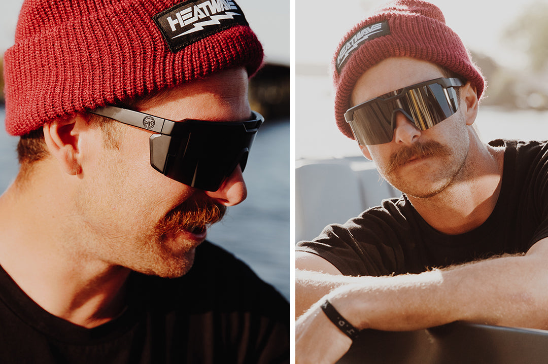 Mustached man wearing Heat Wave Visual Future Tech Sunglasses with black frame and black lens.