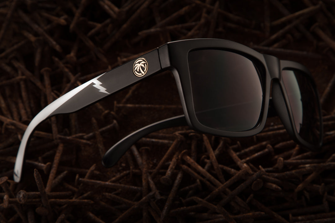 Side view of Heat Wave Visual Rusty Butcher Vise Sunglasses on a bed of rusty nails. 